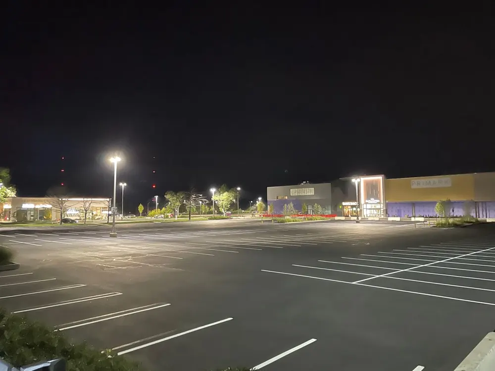 Freshly paved and striped parking lot at night