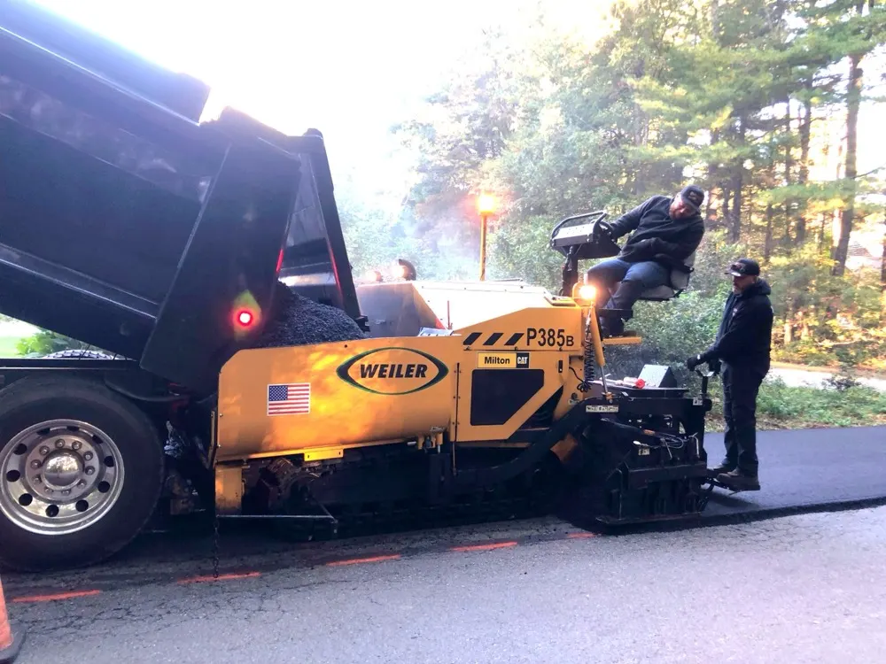 Paving crew laying asphalt with a Weiler paver